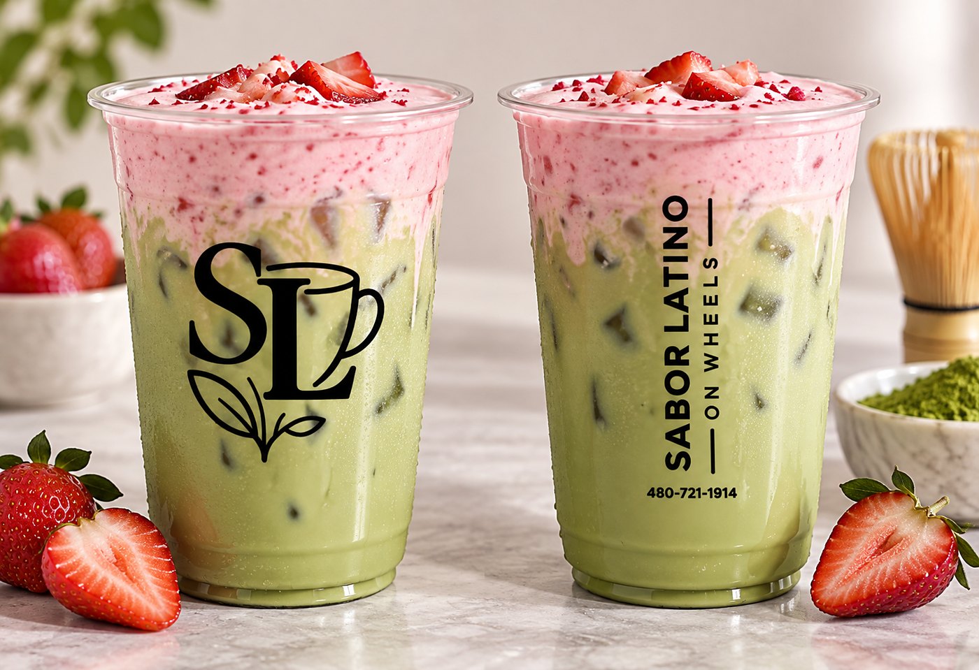 Two strawberry matcha lattes in Sabor Latino cups