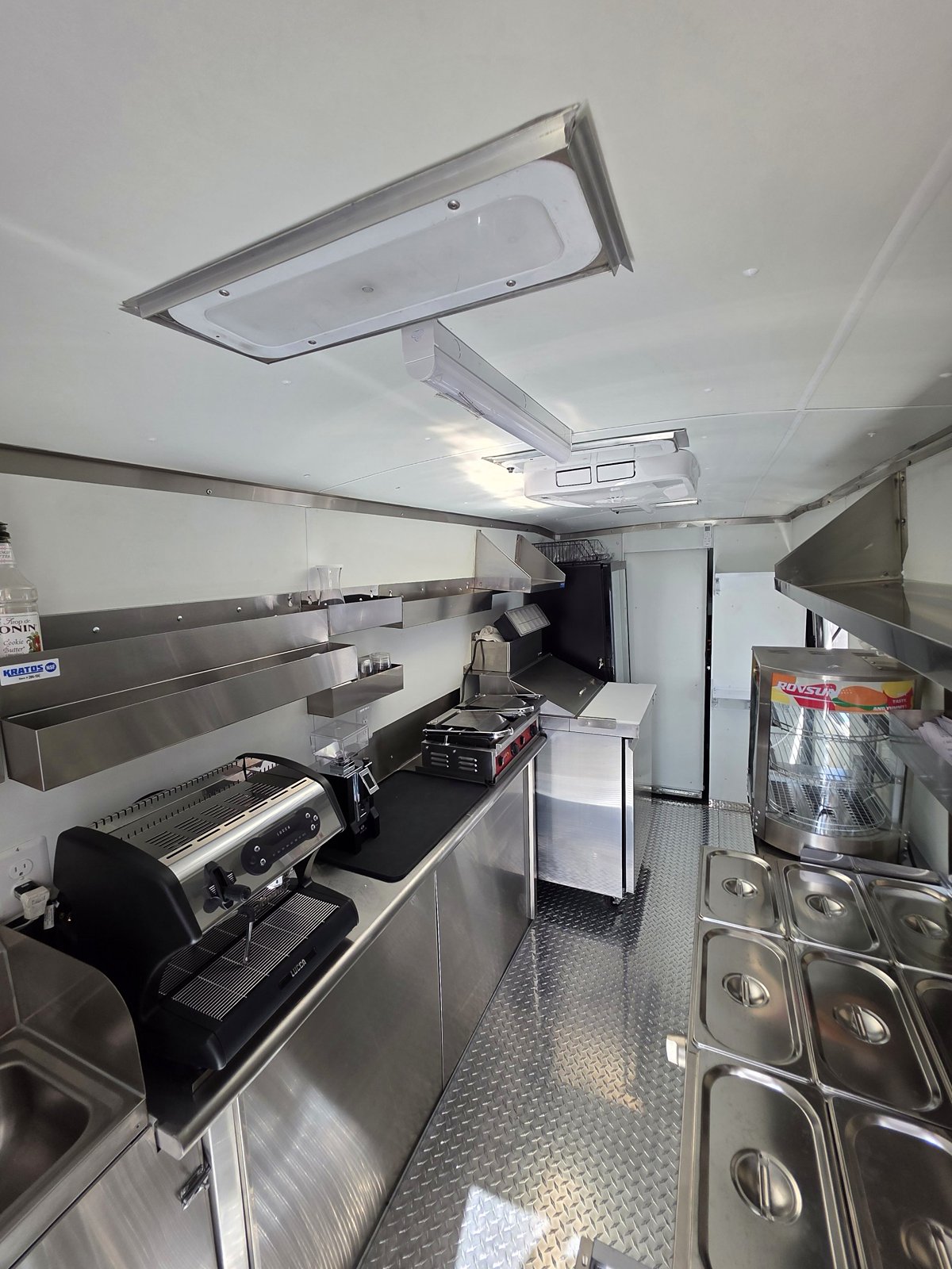 Inside the brand-new food truck: stainless steel kitchen, espresso machine and prep line